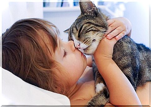 girl kissing cat