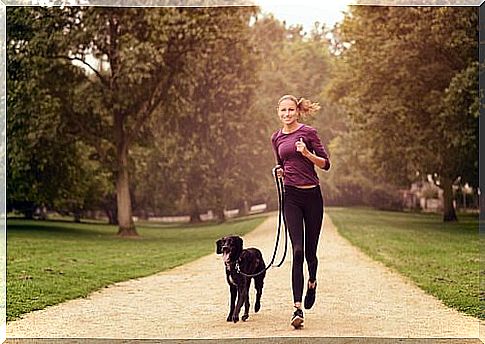 woman running with dog: one of the benefits of having a pet